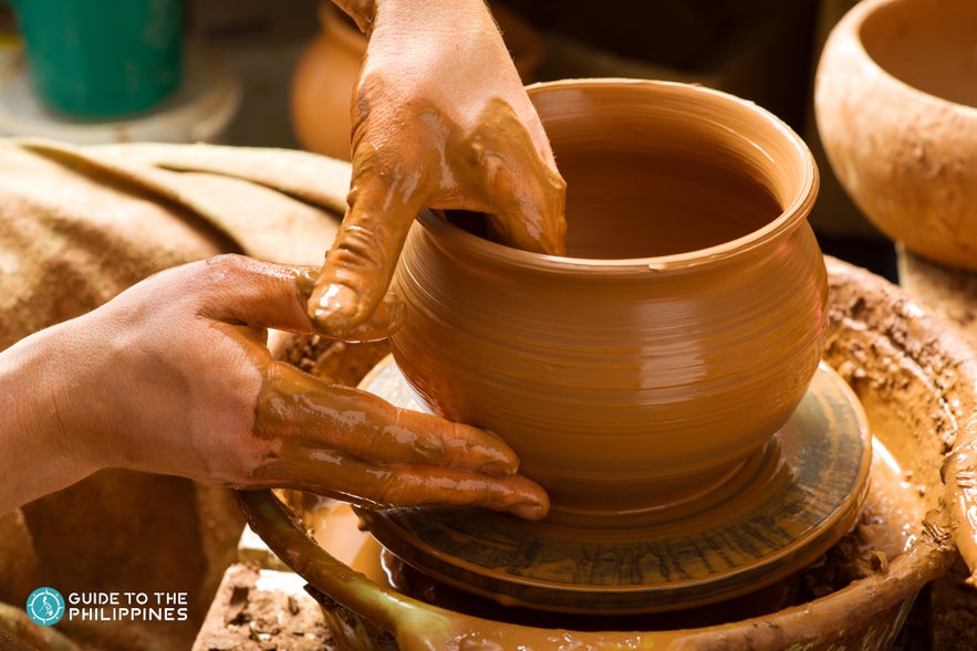 Woman molding a clay pot Woman molding a clay pot