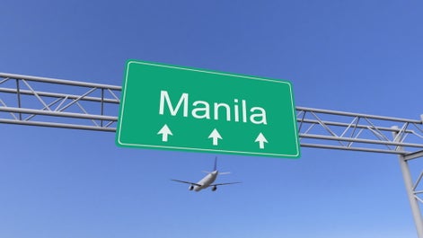 A plane flying over an area near the airport