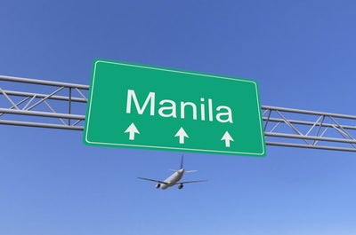 A plane flying over an area near the airport