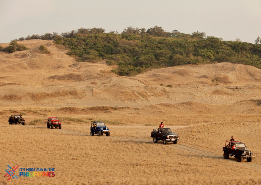 Travelers ride across the La Paz Sand Dunes, Ilocos Norte Travelers ride across the La Paz Sand Dunes, Ilocos Norte