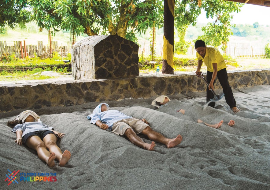 Tourists enjoying volcanic ash spa treatment Tourists enjoying volcanic ash spa treatment