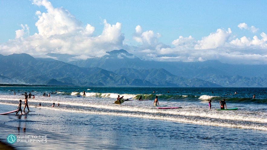 Tourists surfing in Sabang Beach, Baler Tourists surfing in Sabang Beach, Baler