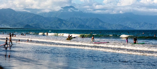 Tourists surfing in Sabang Beach, Baler.jpg