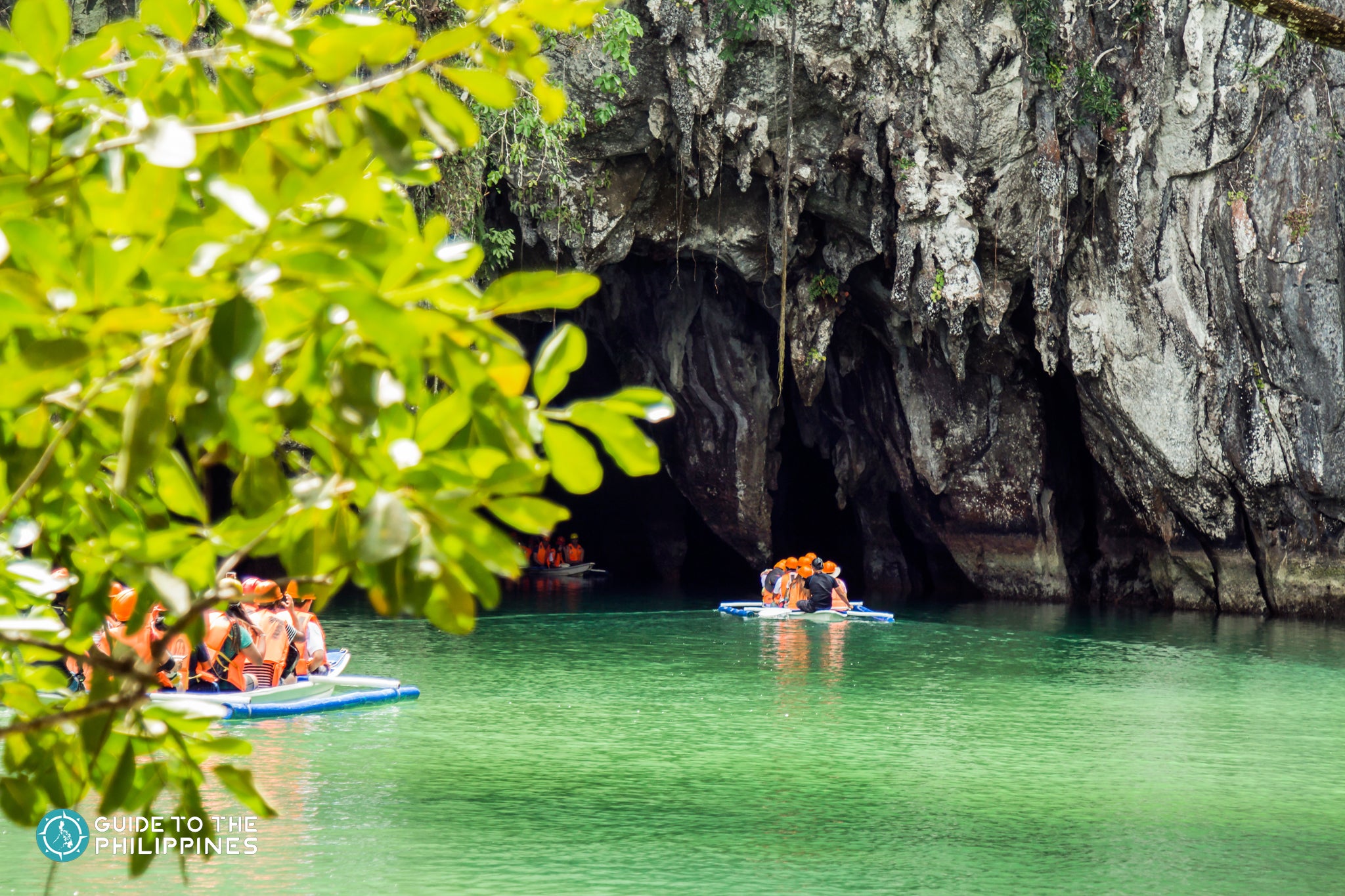 Tourists ride a boat to Puerto Princesa Underground River