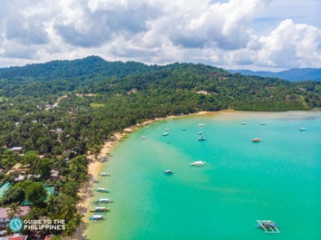 Boats approaching the shore of Port Barton in Palawan
