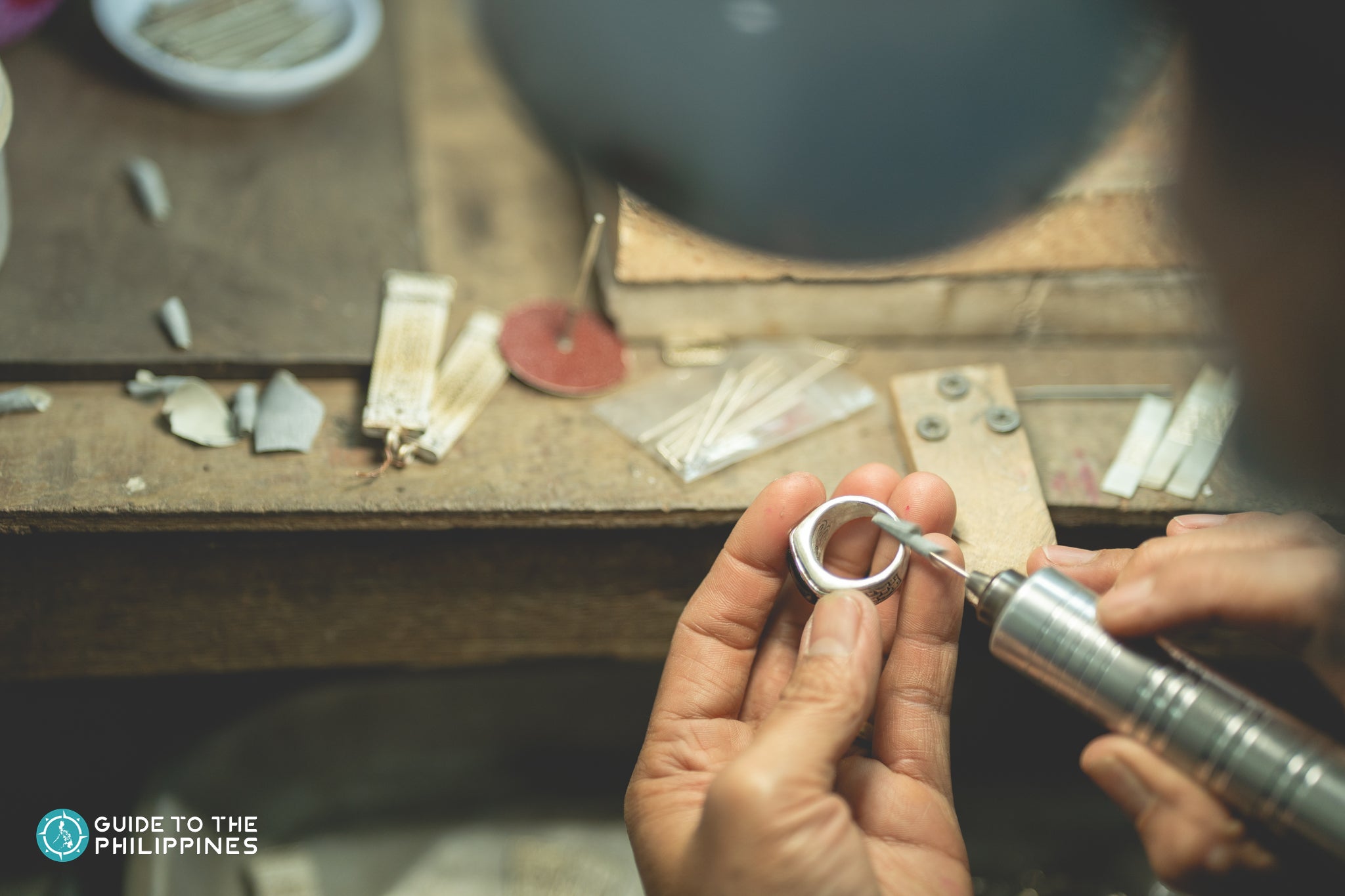 Artisan crafts a silver ring Artisan crafts a silver ring