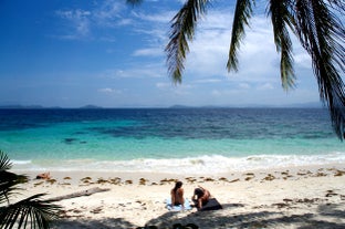Two people enjoying a beach in Port Barton Palawan