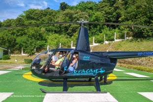 Tourists riding a helicopter to explore Boracay Island