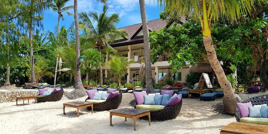 Lounge chairs on Ocean Vida Beach and Dive Resort's beachfront