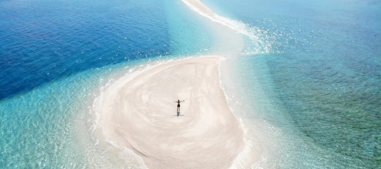 Tourist stands on Kalanggaman Island's sandbar.jpg
