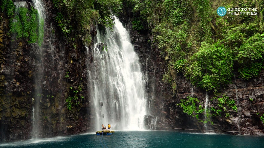 People floating on raft by the Tinago Falls People floating on raft by the Tinago Falls
