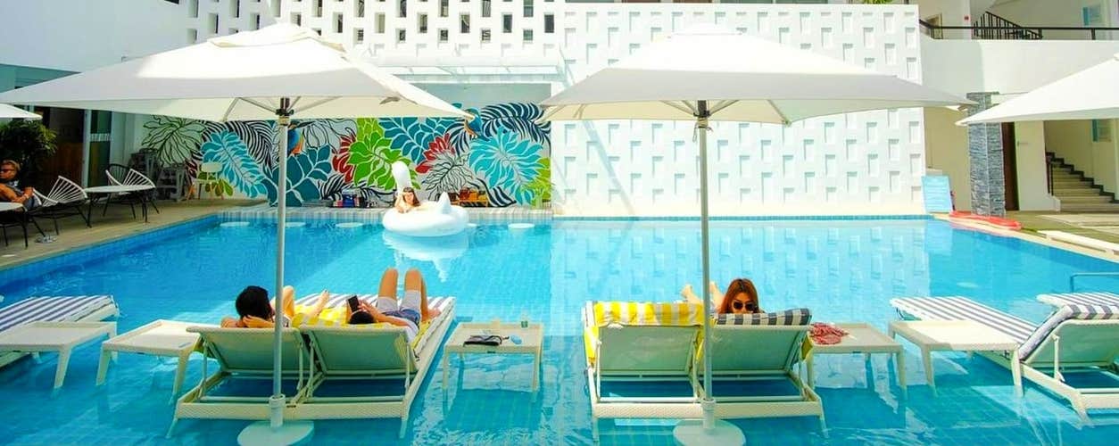 Unwind by the inviting swimming pool at Coast Resort, a relaxing part of this Boracay tour package.