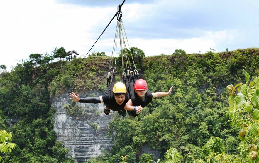 Tourists ziplining in Danao Adventure Park Tourists ziplining in Danao Adventure Park