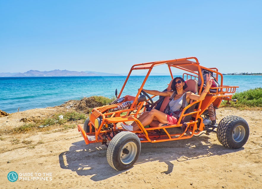 Woman driving buggy on a beach Woman driving buggy on a beach