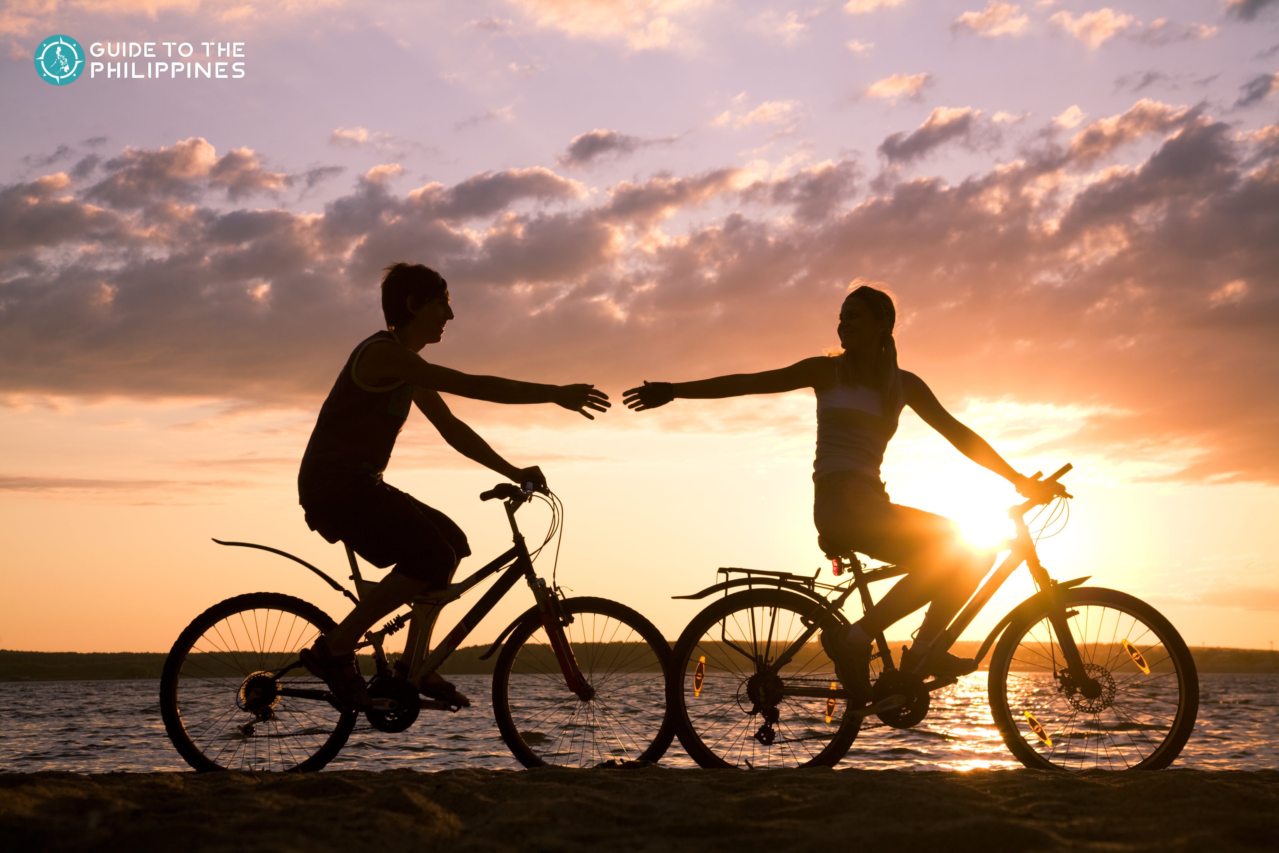 Couple biking at sunset Couple biking at sunset