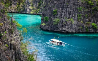 Sail across the crystal-clear waters of Kayangan Lake during this Coron island hopping tour