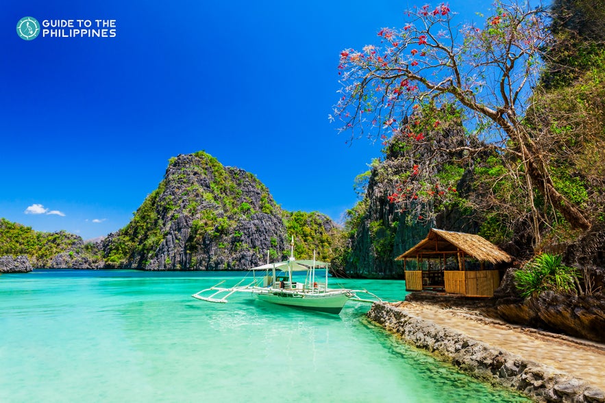 Boat docked in a lagoon in Coron island hopping tours Boat docked in a lagoon in Coron island hopping tours