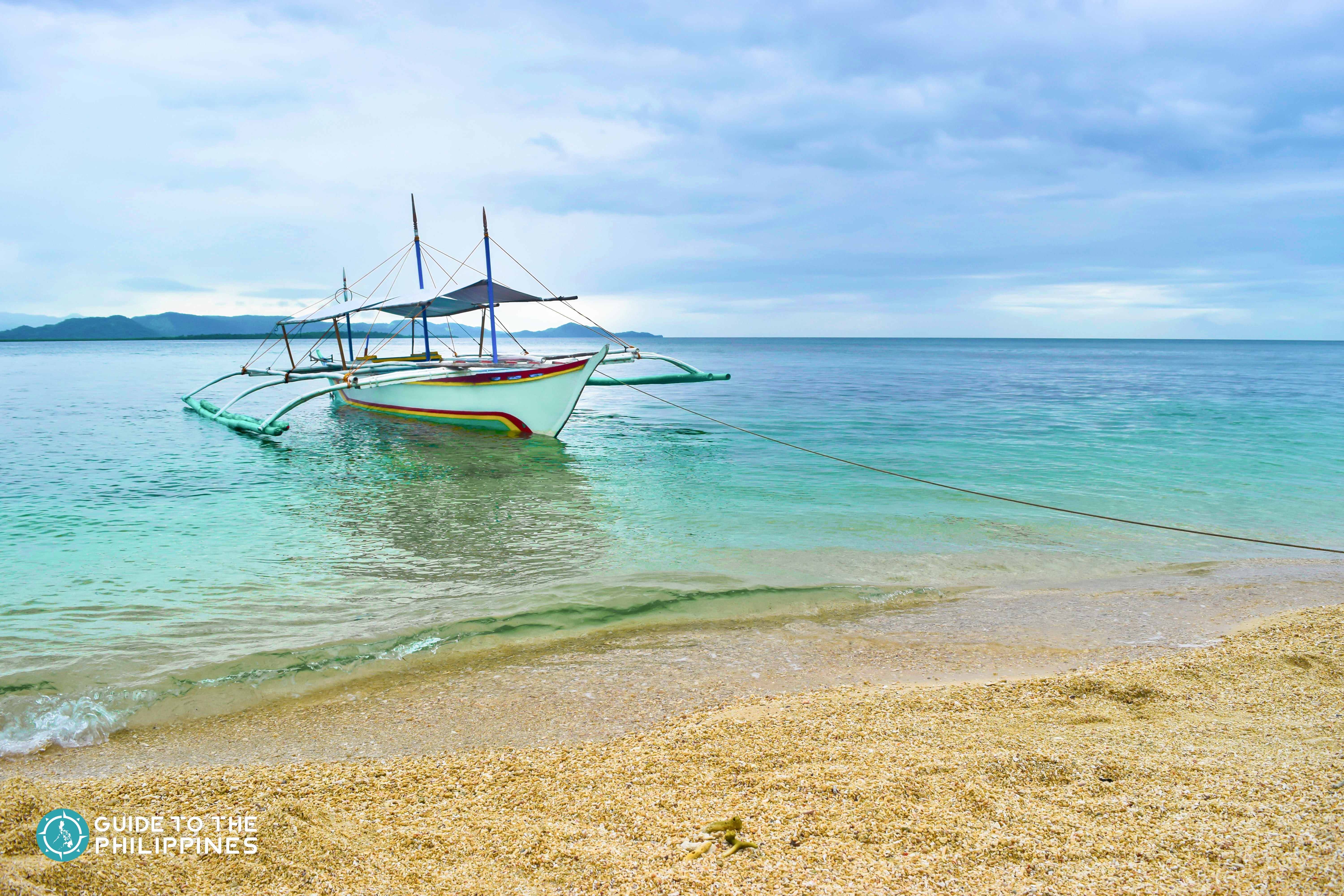 A boat docked on Maniwaya Island