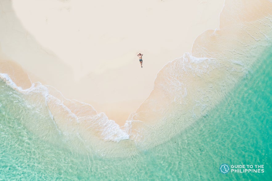 Man relaxing on Daku Island Man relaxing on Daku Island