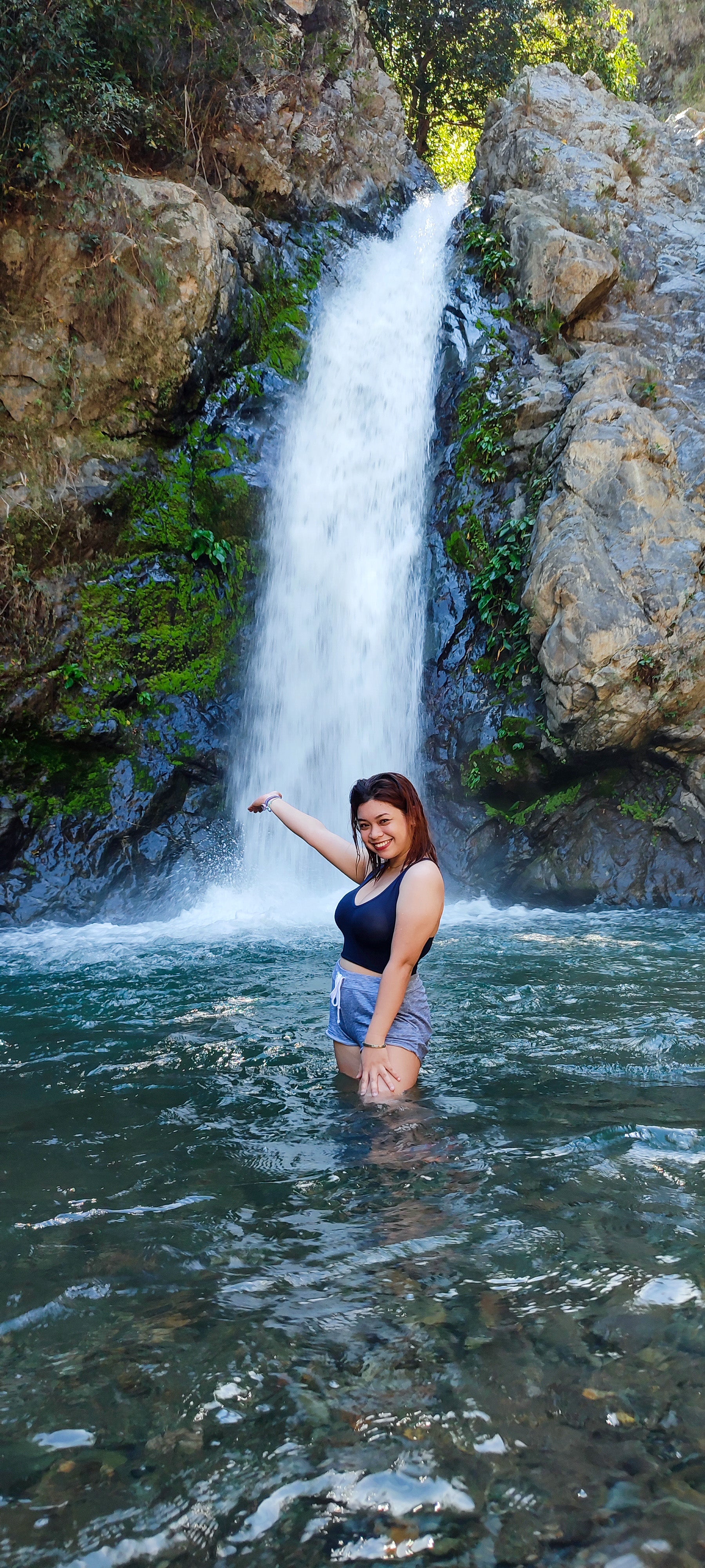 The serene waterfall cascades into a clear pool during this day hike to Mount 387 and Aloha Falls in Nueva Ecija Province.