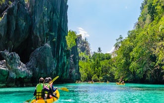 Paddle through the calm waters of Big Lagoon in Palawan Island, during this tour package to Coron Town, El Nido Town, and Puerto Princesa City.