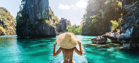 Marvel at the pristine lagoons and turquoise waters framed by majestic limestone cliffs through an El Nido island hopping tour A.