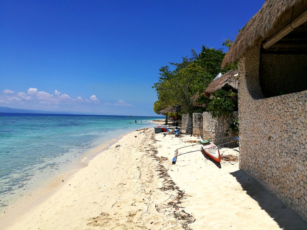 Stroll through white sand beached of Moalboal