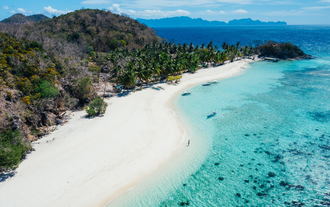 A stunning aerial view of Malcapuya Island, a must-see stop on this Coron town tour C