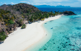 A stunning aerial view of Malcapuya Island, a must-see stop on this Coron town tour C