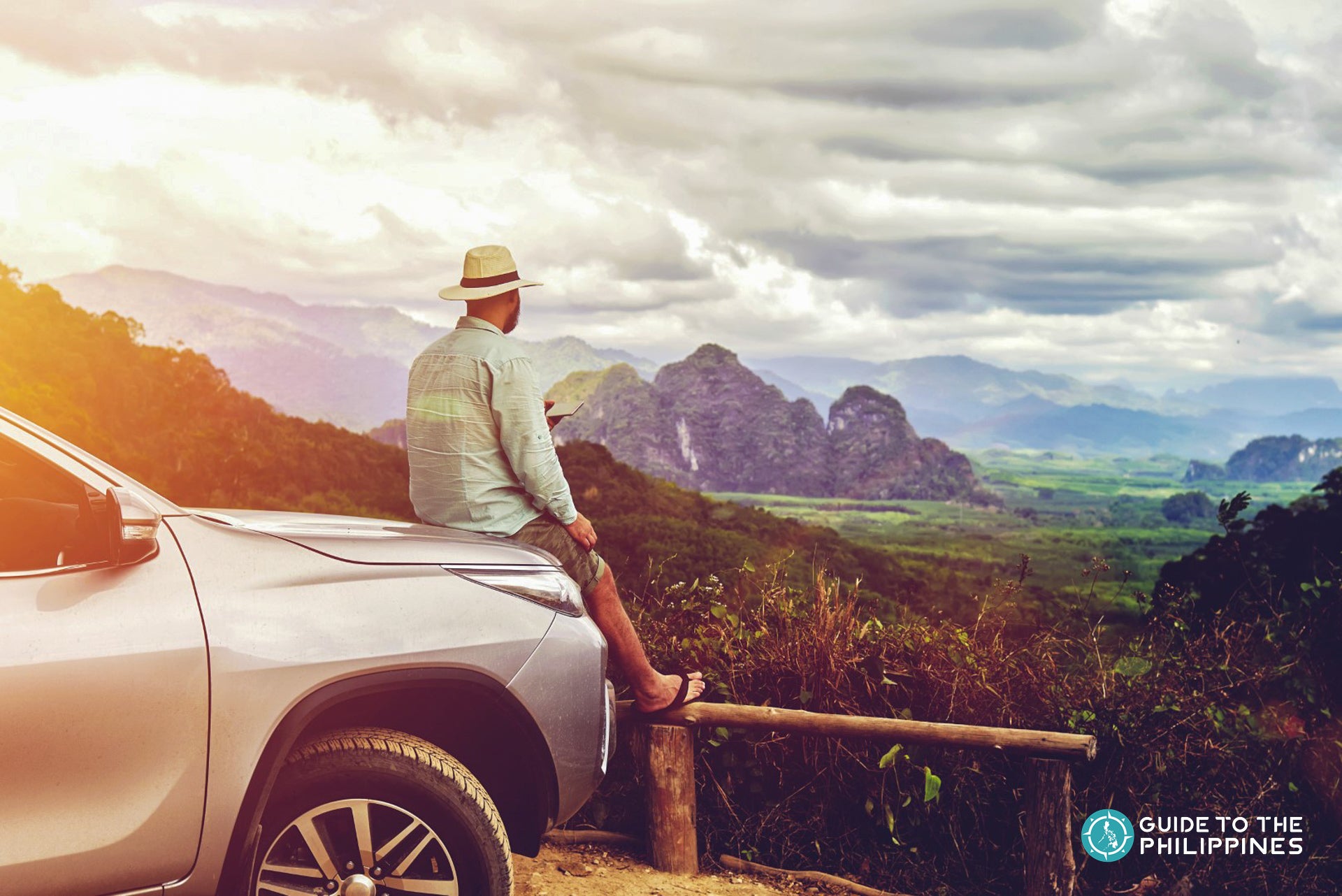 Man resting on car's hood