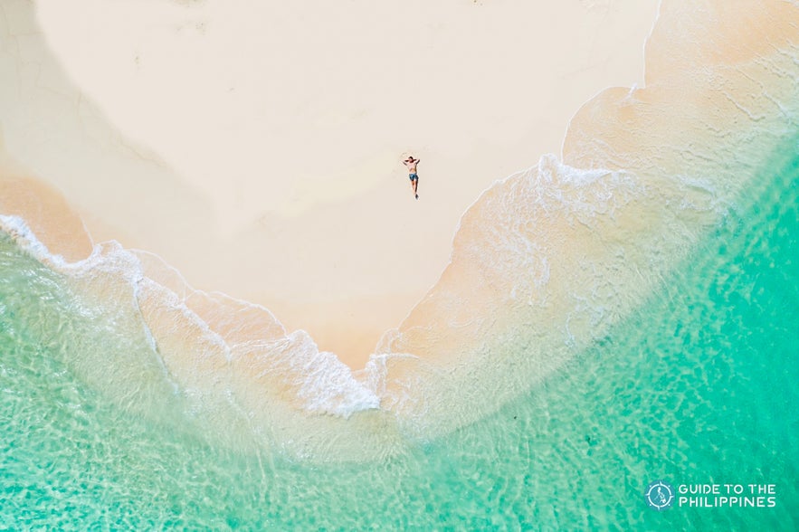 Man relaxing on Daku Island Man relaxing on Daku Island