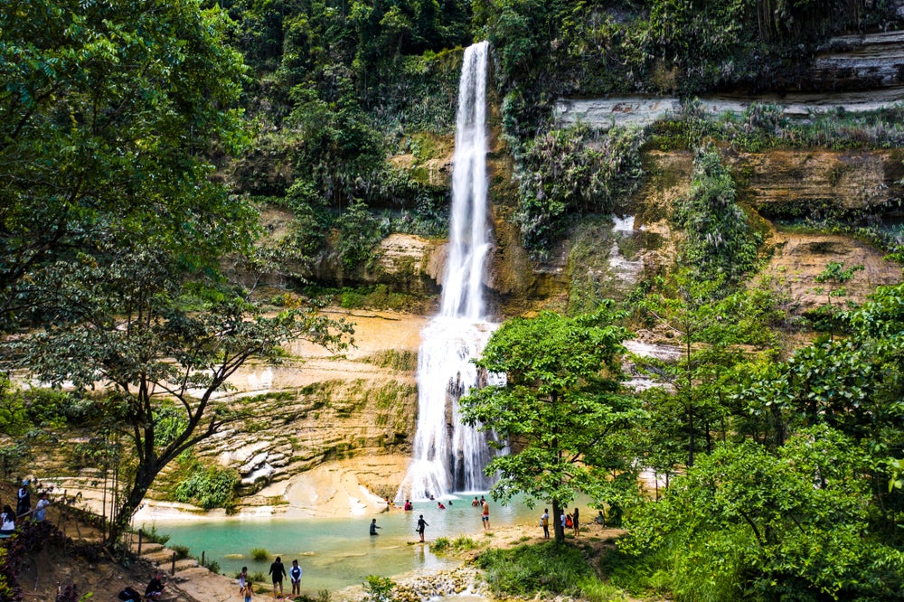 Tourists enjoying the beautiful Can-umantad Falls during their tour on Bohol Island