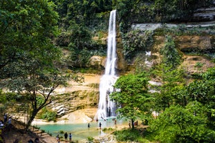 Tourists enjoying the beautiful Can-umantad Falls during their tour on Bohol Island