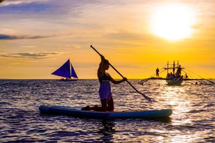 Paddle board while your friend enjoy the sunset cruise in Boracay