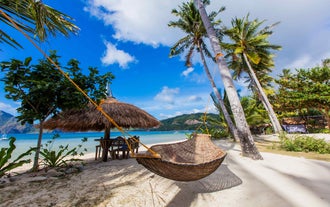 Relax in a beach hammock on Cadlao Island, El Nido, Palawan