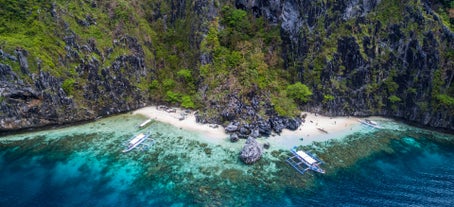 Take a picture and swim at the Secret Beach El Nido Palawan