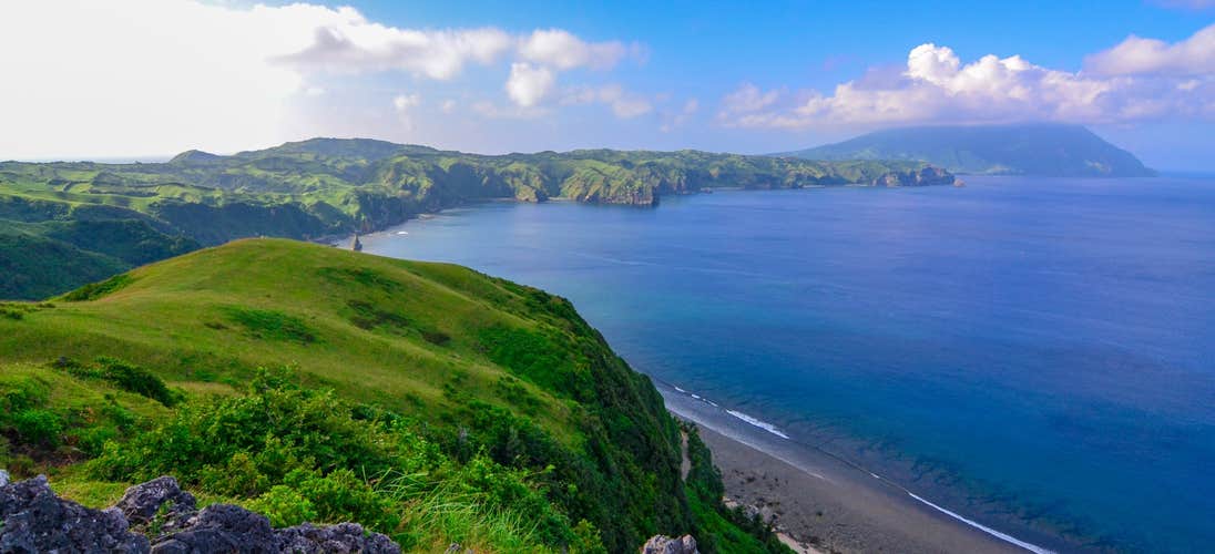 Marvel at the lush rolling hills of South Batan Island, a scenic highlight of your Batanes Province tour package.