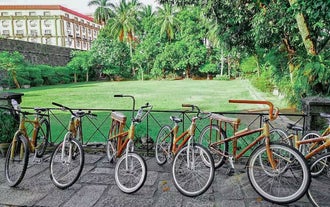 Eco-friendly bicycles neatly lined up, ready for this bamboo bike tour in Intramuros old town