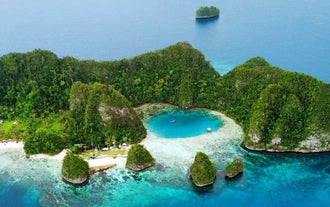 An aerial view of Blue Lagoon’s crystal-clear waters, a highlight of this Dinagat island hopping tour.