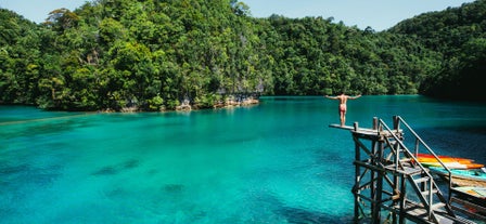 Diving from a wooden plank in Sugba Lagoon