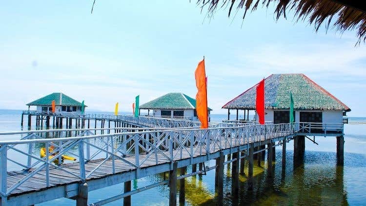 The picturesque boardwalk over turquoise waters enhances the breathtaking experience of this Stilts Calatagan Beach Resort day tour.