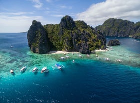 Explore the underwater beauty surrounding Shimizu Island during this tour package to El Nido and Coron Towns with airfare.
