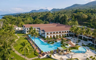 Scenic aerial view of Nouveau Resort and its expansive infinity pool, part of this hotel and tour package in Camiguin Island