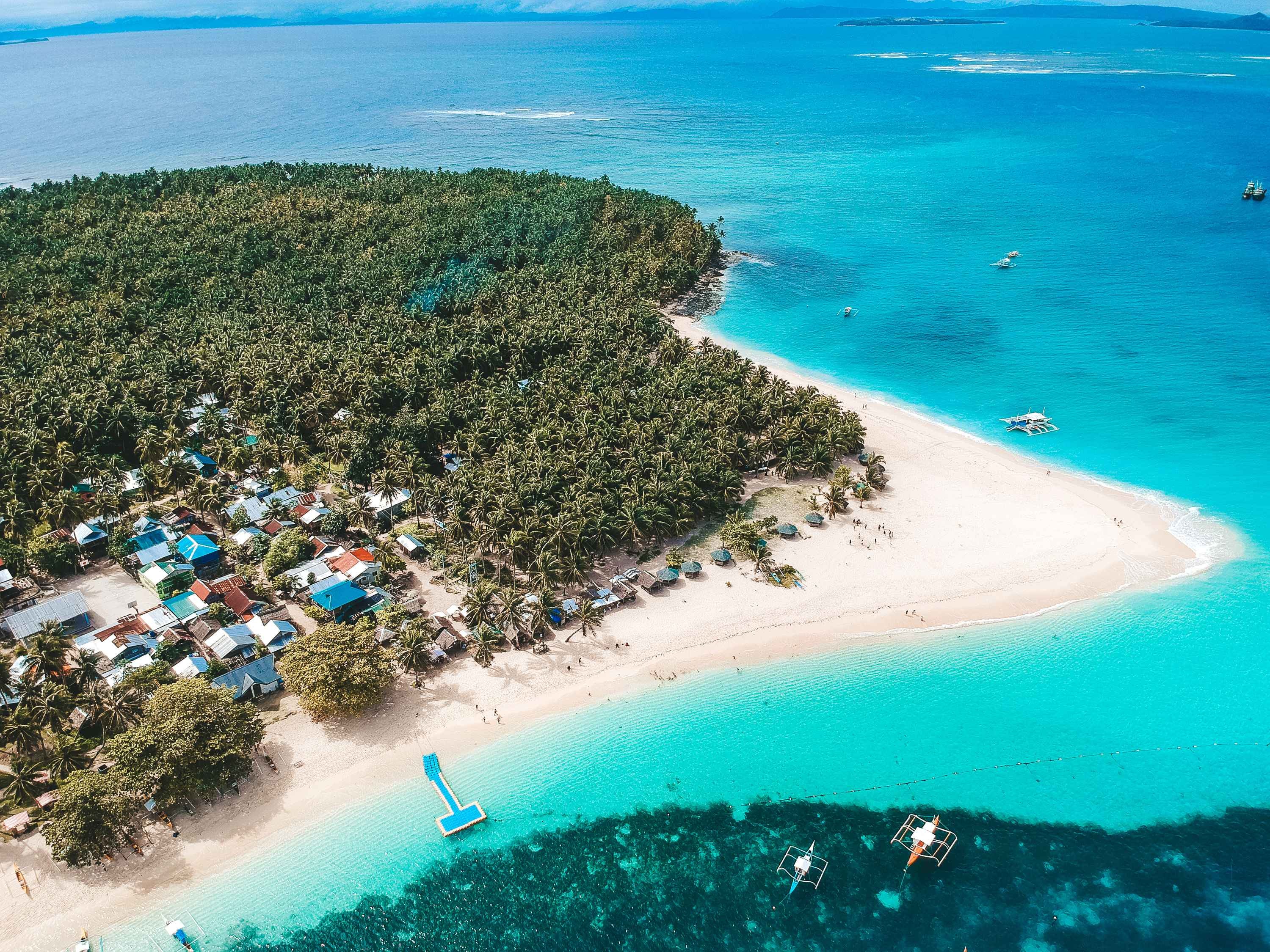 Enjoy this Siargao Island day tour to Daku Island, showcasing its wide white-sand beach and blue waters