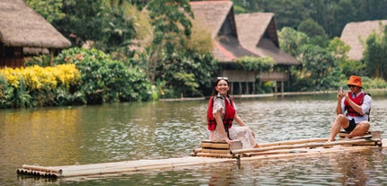 Traditional Filipino bamboo rafts gliding along the river during a day tour at Villa Escudero Plantations & Resort.