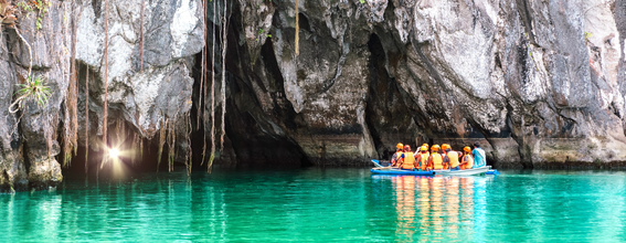 Tourists exploring the Puerto Princesa Underground River, a highlight of one of the tours included in this Coron town-El Nido town-Puerto Princesa City package