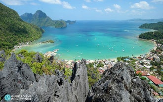 Savor a breathtaking sight during the canopy walk in Taraw Cliff, El Nido Town, with wide views of emerald waters, towering limestone cliffs, and lush greenery below.