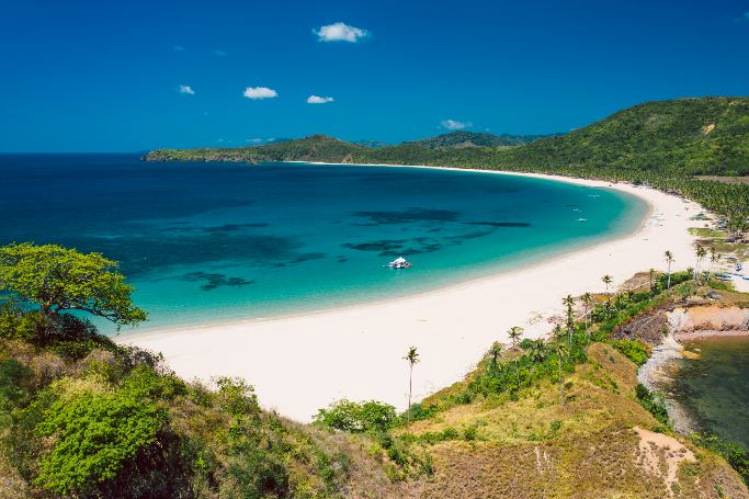 The scenic shoreline of Nacpan Beach, which you can visit during a cruise day trip in El Nido town