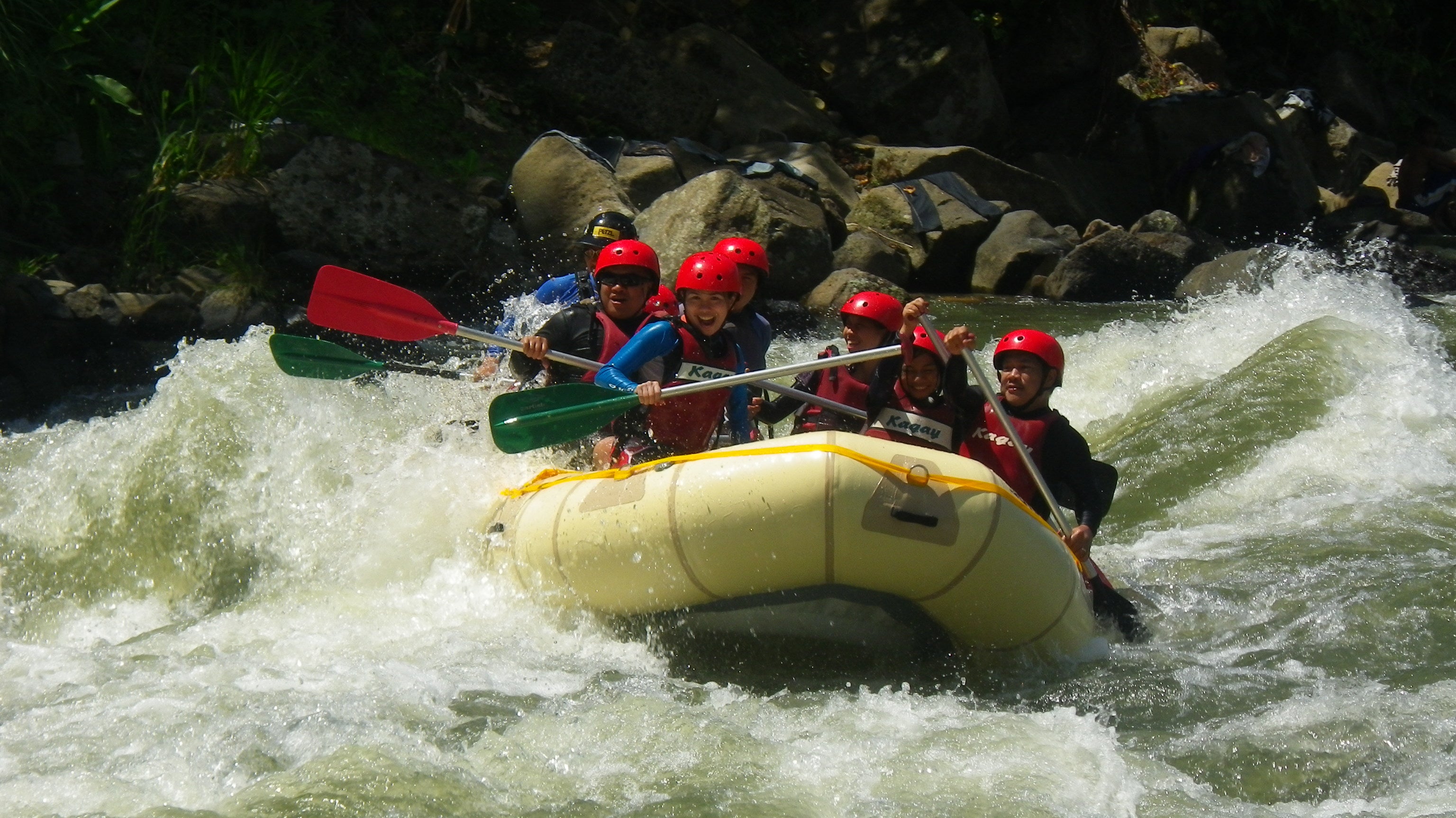 Adventurers navigating rapids during a whitewater rafting experience in Cagayan de Oro, part of this 3-day and 2-night CDO tour package.