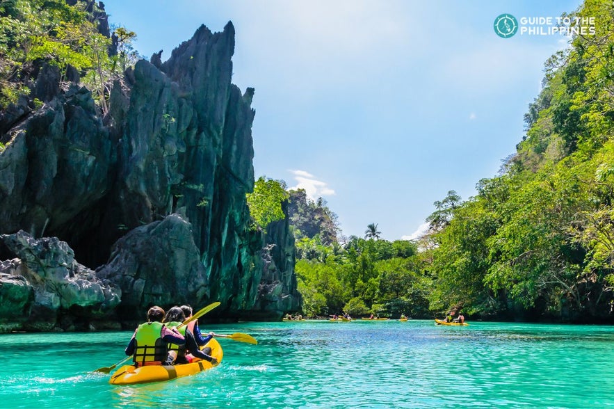 Tourists kayaking in Big Lagoon El Nido Palawan Tourists kayaking in Big Lagoon El Nido Palawan